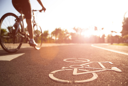 Close up cycling logo image on road with athletic women cyclist 