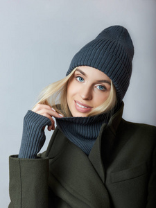 Woman in coat, spring clothes, a Snood scarf, a hat and gloves. 