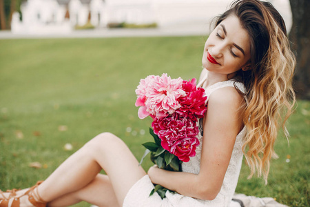 Elegant and stylish girl in a summer garden