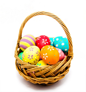 Colorful handmade painted easter eggs in the basket isolated 