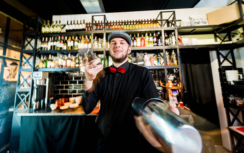 Bartender is making cocktail at bar counter. Fresh cocktails. 