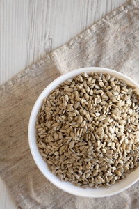 Raw Sunflower Seed Kernels in a white bowl, overhead view. Flat 