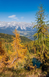 Calm autumn Alps mountain lake with clear transparent water and 