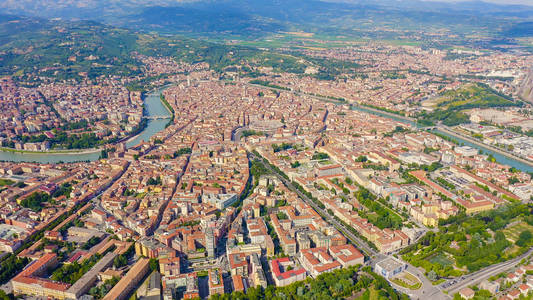 Verona, Italy. Flying over the historic city center. Roofs of ho