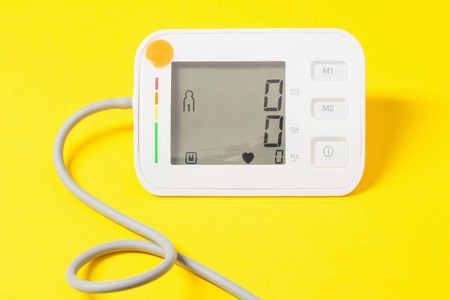 modern tonometer on yellow background 