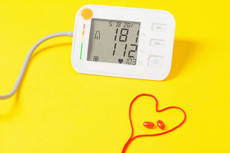 modern tonometer on yellow background 