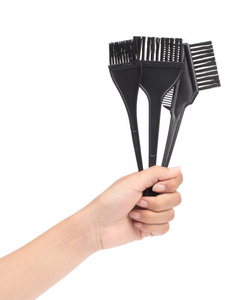 hand holding set of Comb brush for hair dying isolated on white 