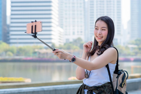 Beautiful asian tourist woman use video call via a smartphone in