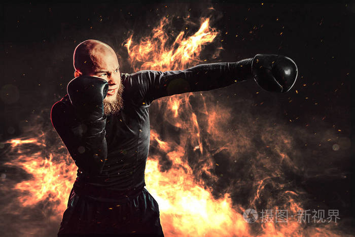 运动员拳击训练直接击中背景与火拳击运动概念