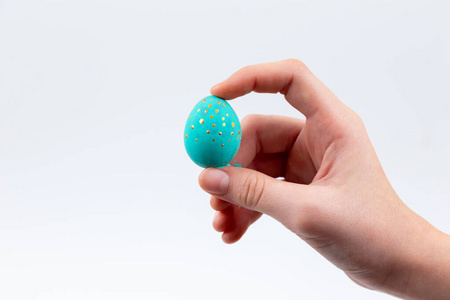 Easter holiday concept. Female hands coloring Easter quail eggs 