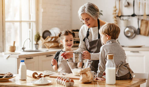 happy family grandmother and grandchildren cook in the kitchen, 