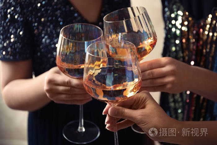 女人用白葡萄酒碰杯特写