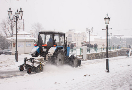  Snowplow truck removing snow on the street after blizzard. Inte