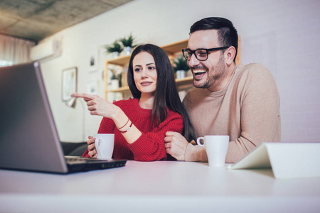 Happy couple doing business together working at small  on 