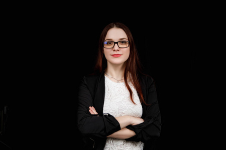 Portrait of young business woman with glasses in a black jacket 