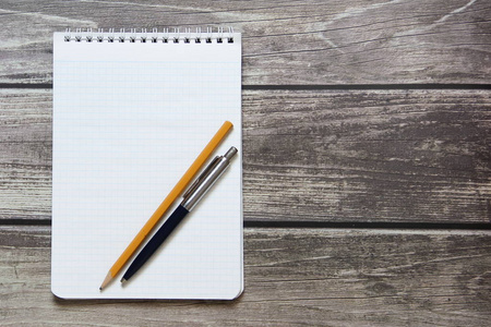 Notepad with a blank white sheet in a checker paper with ball pe