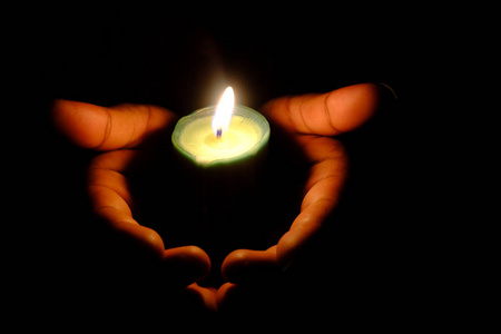 close up of burning candle at night 