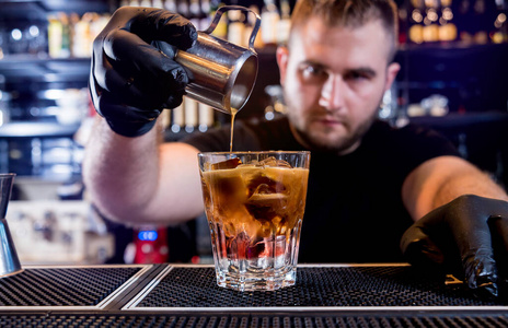 Bartender is making cocktail at bar counter. Fresh cocktails. 