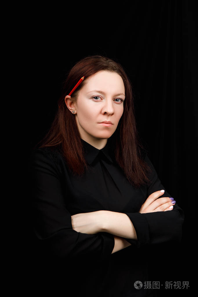 Portrait of successful business woman in 
a black shirt with cro