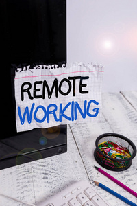 文字写作远程工作。业务概念是指员工主要从家用笔记本电脑上贴在键盘和文具旁的黑色电脑屏幕上。