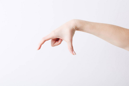 Empty female hand making gesture like holding something on white