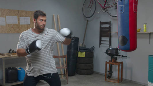 Athlete is practicing punches on a punching bag 