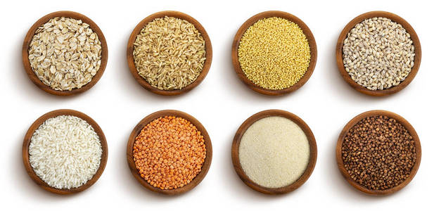 白色背景隔离的碗中的谷类,谷物和种子,俯视图照片