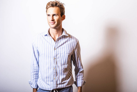 Elegant young handsome man in stylish blue shirt.