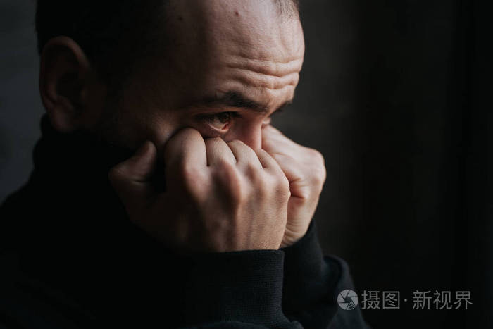 近一点悲伤的胡子男人看着窗外
