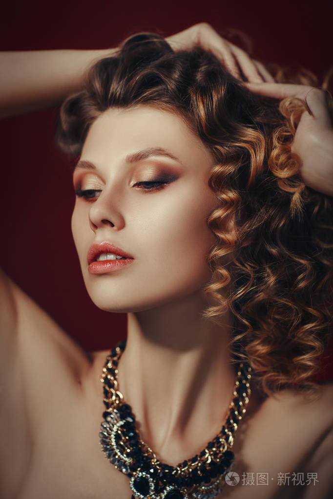 美丽的女性脸天生完美的皮肤一个漂亮的女孩穿着蓝色上衣在红色的背景