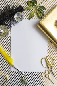 Empty paper, crumpled ball, pencil, potted plants on white desk 