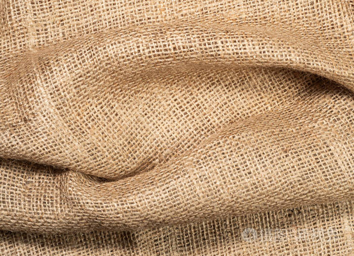 皱巴巴的粗麻布织物,近距离观察.棕色粗麻布,抽象背景.麻袋的质地.