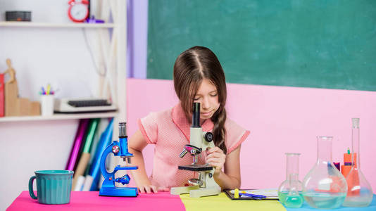 女生生物课试管。科学课。学校实验室。拿着显微镜的小女孩。科学实验。精彩的一课。探索微生物学。学习生物学。生物教育