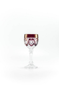 Empty crystal red patterned wine glass. Photographed in the stud