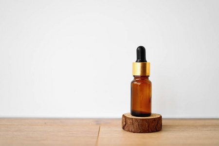 Brown bottle with dropper on white background. Essential oils or