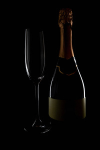 Empty champagne glass tea bottle on black background, magazine a