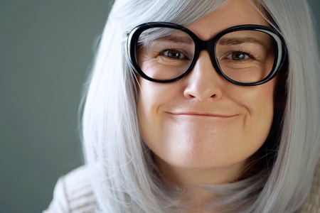 Emotional portrait of a woman in big black glasses.