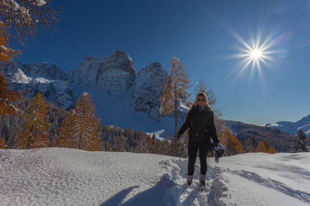 Blonde girl with a snowcovered Dolomite landscape in the backgr