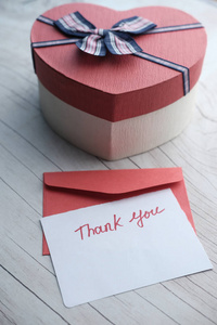 thank you letter with gift box on table 