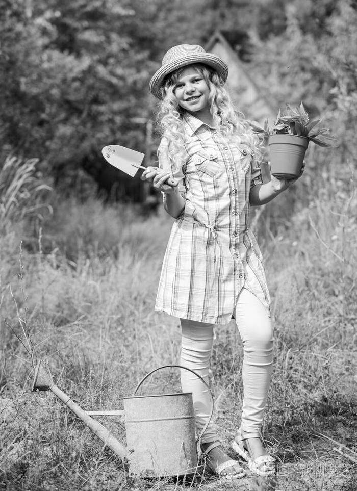 农场女孩.快乐的童年.种植植物.小孩子拿着花盆.春天乡村工程.