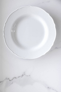 Empty plate on white marble table as background, food and menu