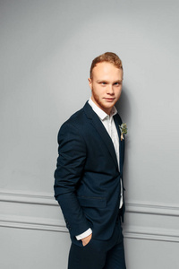 Elegant and attractive redhaired guy in a suit