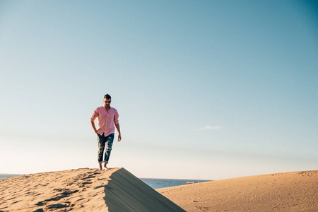 在西班牙大加那利群岛的马斯帕洛马斯海滩散步,男人们在马斯帕洛马斯