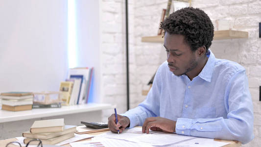 Ambitious African Man reading the Documents 