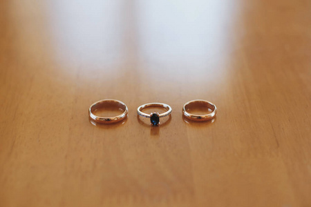 Elegant gold wedding rings of the bride and groom.