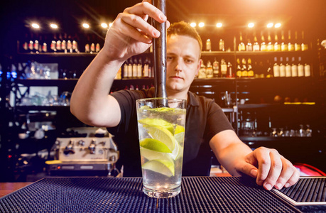 Bartender is making cocktail at bar counter. Fresh cocktails. 