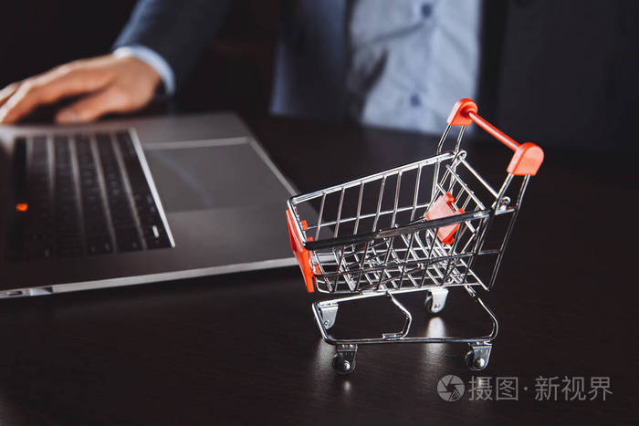 笔记本电脑键盘上的拉杆箱。关于网上购物，网上购物是一种电子商务形式，允许消费者通过互联网直接从卖家处购买商品。