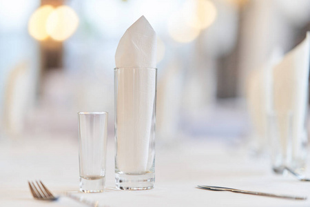 Glass with a glass on the festive table. 