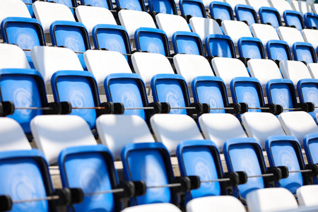 Empty tribunes in swimming pool. Modern plastic colored seats be