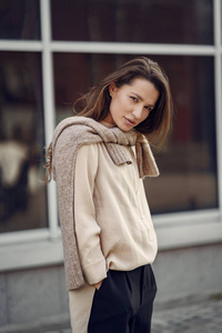 Elegant woman in a brown shirt in a spring city